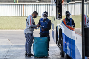 SANTIAGO DE CHILE, CHILE- In the photos taken on August 19, 2020, health professionals during a free mobile PCR testing operation for COVID-19 at the Bus Terminal in Santiago de Chile. Chile registered 1,233 new coronavirus infections in the last 24 hours, the lowest number in more than three months, while the country advances deconfinement measures and imposes new quarantines by sectors.