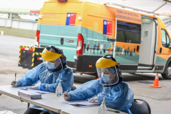 SANTIAGO DE CHILE, CHILE- In the photos taken on August 19, 2020, health professionals during a free mobile PCR testing operation for COVID-19 at the Bus Terminal in Santiago de Chile. Chile registered 1,233 new coronavirus infections in the last 24 hours, the lowest number in more than three months, while the country advances deconfinement measures and imposes new quarantines by sectors.