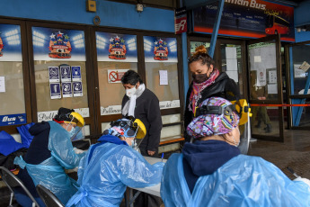 SANTIAGO DE CHILE, CHILE- In the photos taken on August 19, 2020, health professionals during a free mobile PCR testing operation for COVID-19 at the Bus Terminal in Santiago de Chile. Chile registered 1,233 new coronavirus infections in the last 24 hours, the lowest number in more than three months, while the country advances deconfinement measures and imposes new quarantines by sectors.