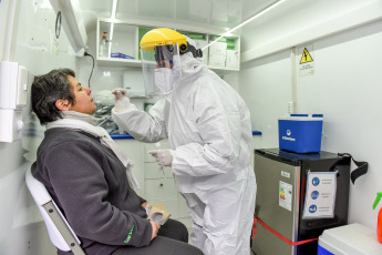SANTIAGO DE CHILE, CHILE- In the photos taken on August 19, 2020, health professionals during a free mobile PCR testing operation for COVID-19 at the Bus Terminal in Santiago de Chile. Chile registered 1,233 new coronavirus infections in the last 24 hours, the lowest number in more than three months, while the country advances deconfinement measures and imposes new quarantines by sectors.