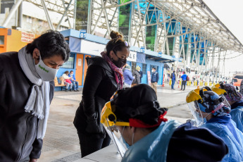 SANTIAGO DE CHILE, CHILE- In the photos taken on August 19, 2020, health professionals during a free mobile PCR testing operation for COVID-19 at the Bus Terminal in Santiago de Chile. Chile registered 1,233 new coronavirus infections in the last 24 hours, the lowest number in more than three months, while the country advances deconfinement measures and imposes new quarantines by sectors.